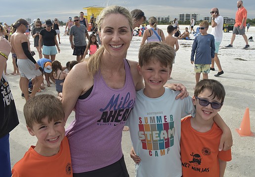 Brody Floyd, 6, his mom Sara Floyd, and brothers Jacob Floyd, 9, and Benjamin Floyd, 6, prepare for the run.