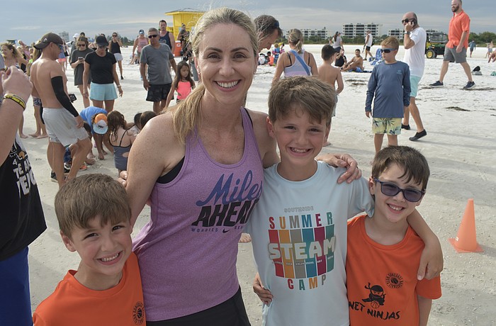 Brody Floyd, 6, his mom Sara Floyd, and brothers Jacob Floyd, 9, and Benjamin Floyd, 6, prepare for the run.