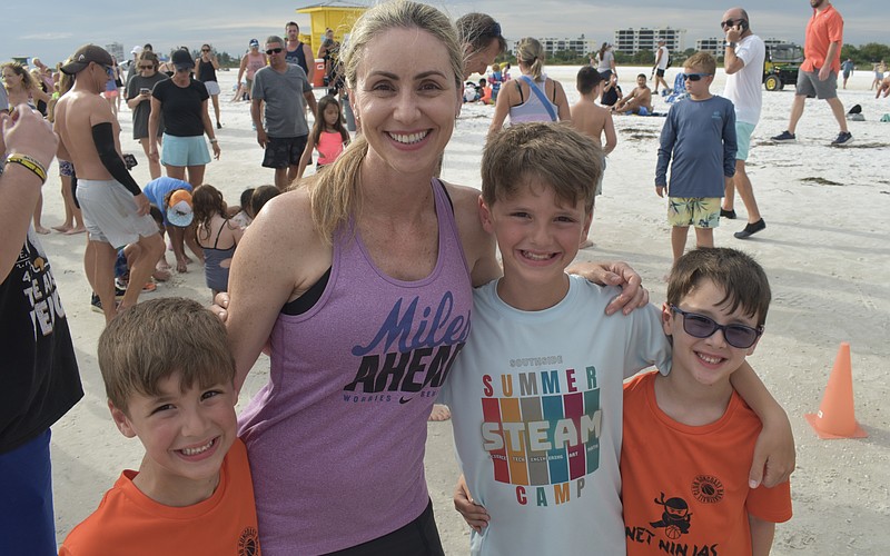 Brody Floyd, 6, his mom Sara Floyd, and brothers Jacob Floyd, 9, and Benjamin Floyd, 6, prepare for the run.