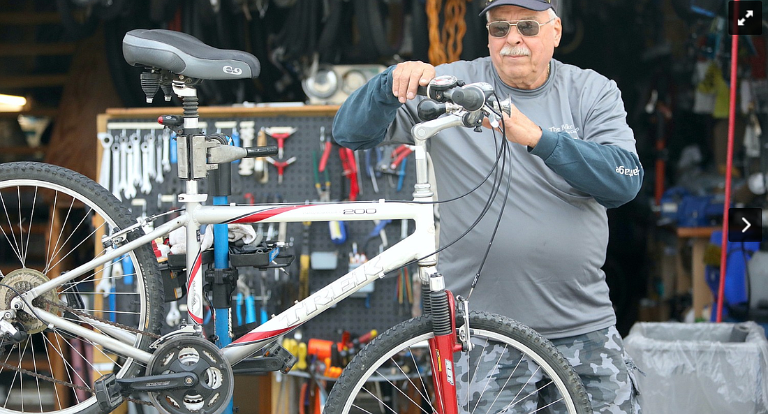 Joe Golan works on a bike. File photo by Brent Woronoff