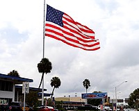 A giant American flag has flown above Sarasota Ford since the 1970s.