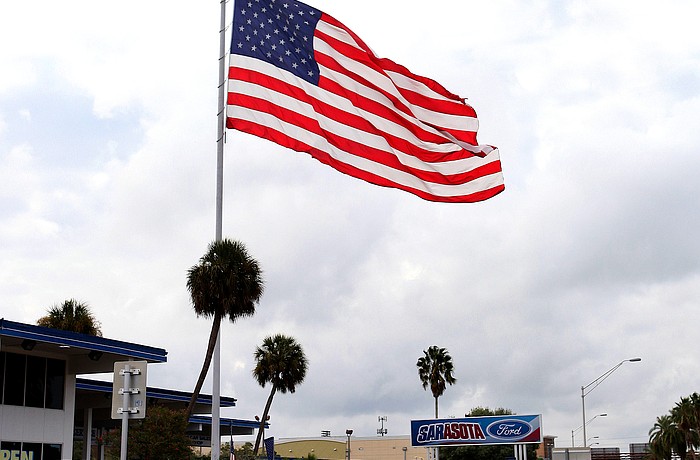 A giant American flag has flown above Sarasota Ford since the 1970s.
