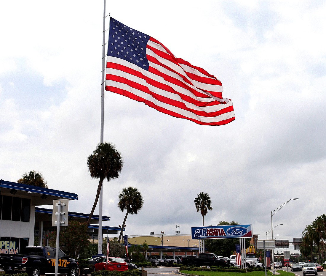 A giant American flag has flown above Sarasota Ford since the 1970s.