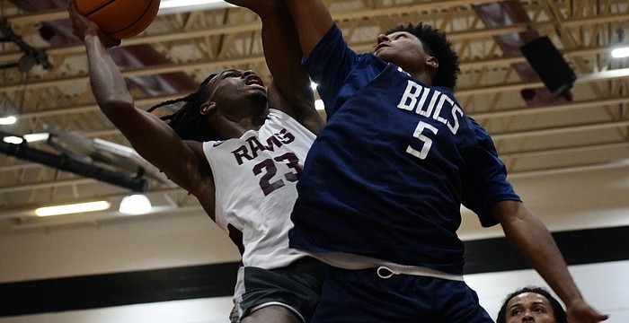 Carter Evans (left), a rising senior forward with Riverview boys basketball, drives toward the rim. The Hoop Vibe Summer League is an opportunity for him to workshop his skills in a real-game setting.