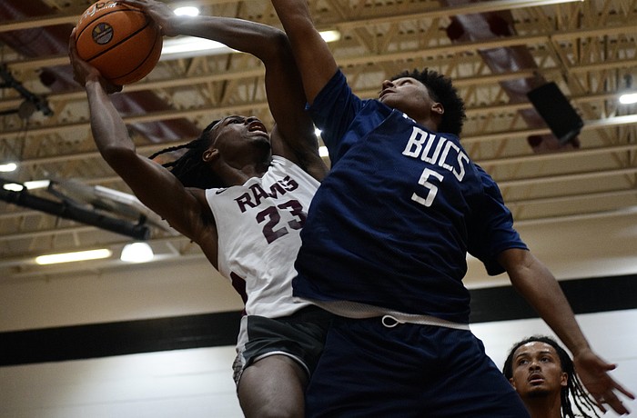 Carter Evans (left), a rising senior forward with Riverview boys basketball, drives toward the rim. The Hoop Vibe Summer League is an opportunity for him to workshop his skills in a real-game setting.