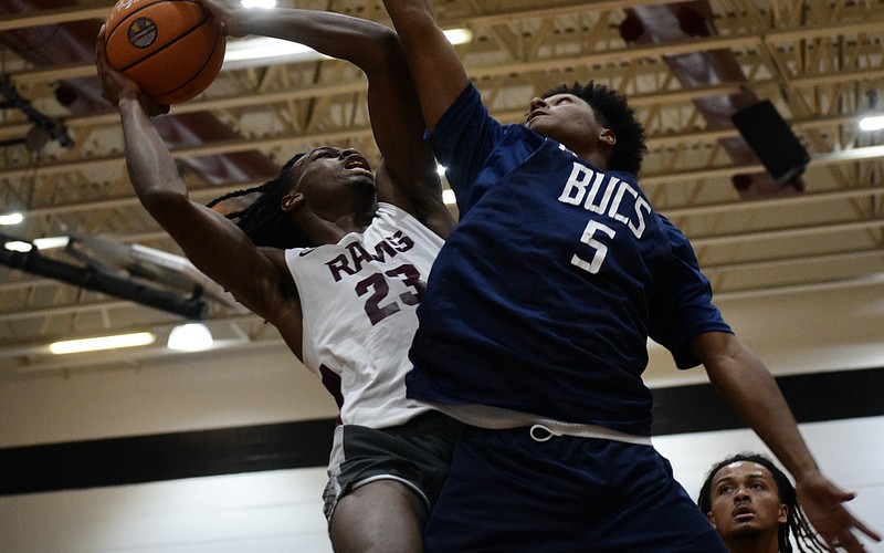 Carter Evans (left), a rising senior forward with Riverview boys basketball, drives toward the rim. The Hoop Vibe Summer League is an opportunity for him to workshop his skills in a real-game setting.