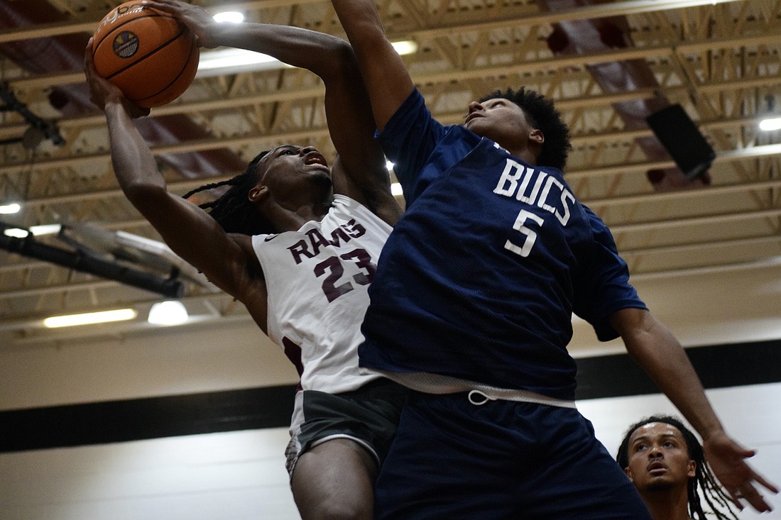 Carter Evans (left), a rising senior forward with Riverview boys basketball, drives toward the rim. The Hoop Vibe Summer League is an opportunity for him to workshop his skills in a real-game setting.