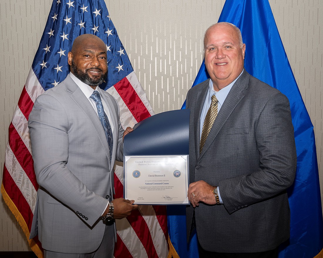 FBI Unit Chief Corey Hudson (left) presents Bunnell Police Chief David Brannon (right) with a Certificate of Completion for the FBI National Command Course, Session 8. Photo courtesy of the Bunnell Police Department.