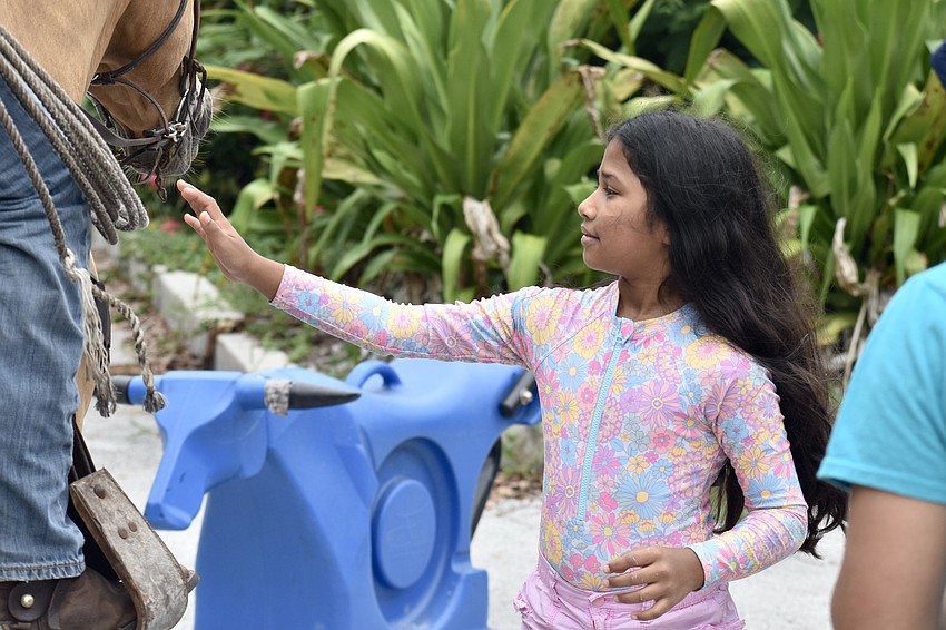 Antonella Rojas, 9, pets Slick.