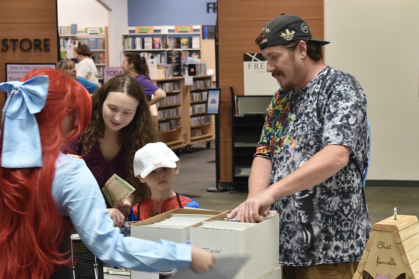 Sara Miller hosts Victoria Scarfe, Greyson Podniestivanski, 7, and Joshua Schwochert at a table.