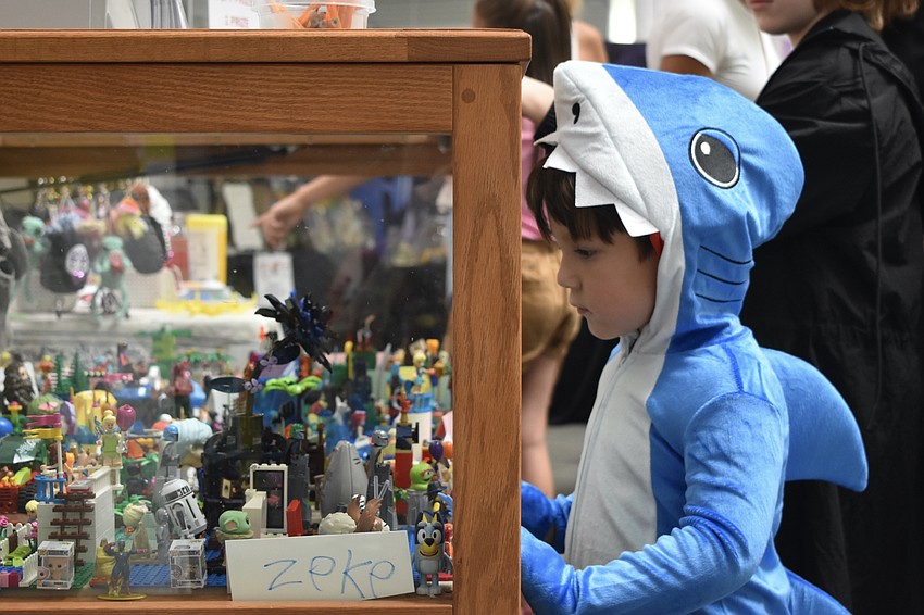 Milo Harvey, 3, looks over a Lego display.