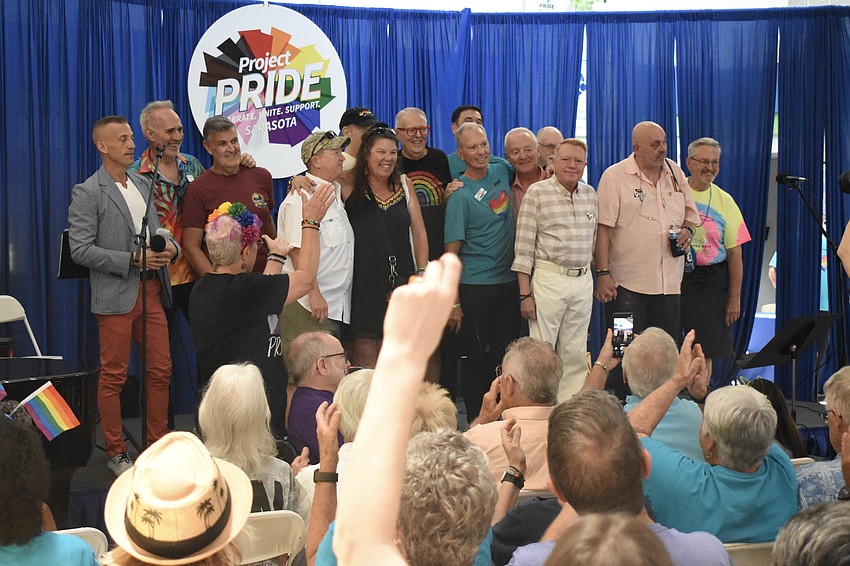 A group of couples comes to the stage during a legacy couples tribute.