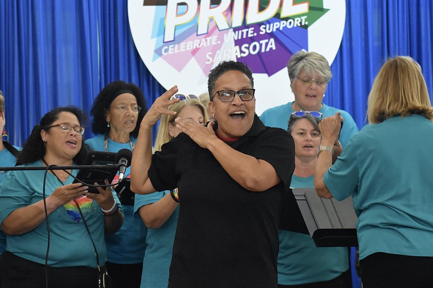 The Diversity: The Voices of Sarasota choir performs, with sign language interpretation Janine McCarthy at the front of the stage.