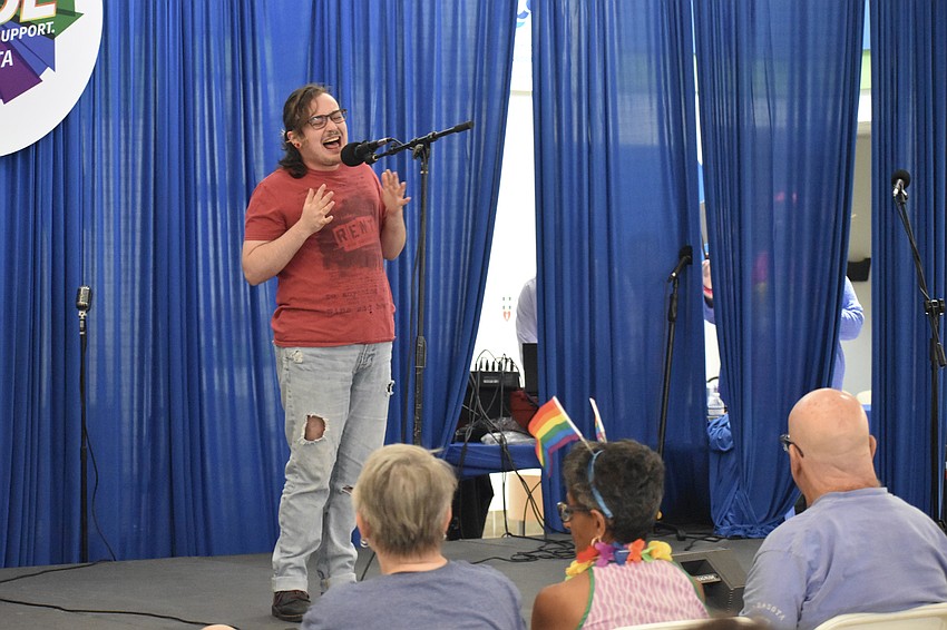 Michael Luck of Dingbat Theatre Project performs on stage.