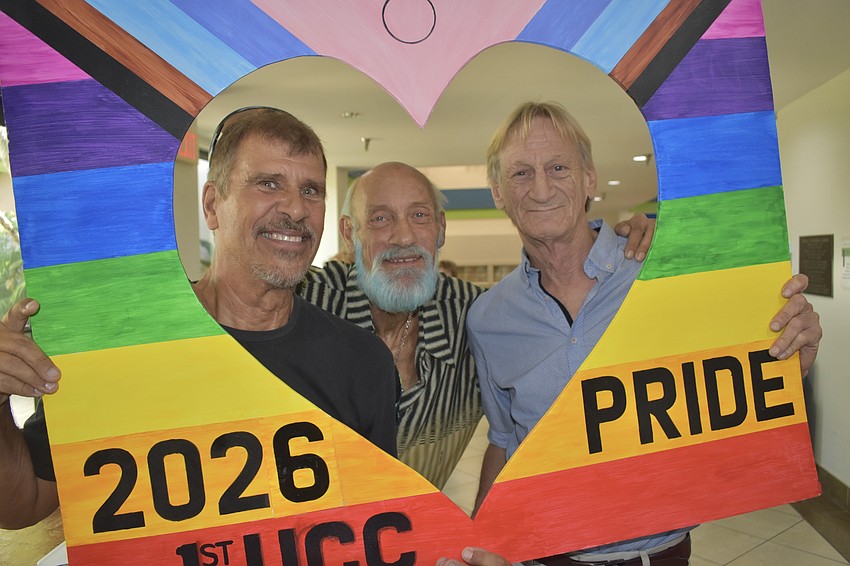 Tom Poklewski, Jory Courtier and Brad Blethen pose inside a frame from First Congregational United Church of Christ.