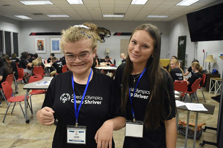 Lexi, 14, enjoys lunchtime alongside Sarenna Borda, a senior.