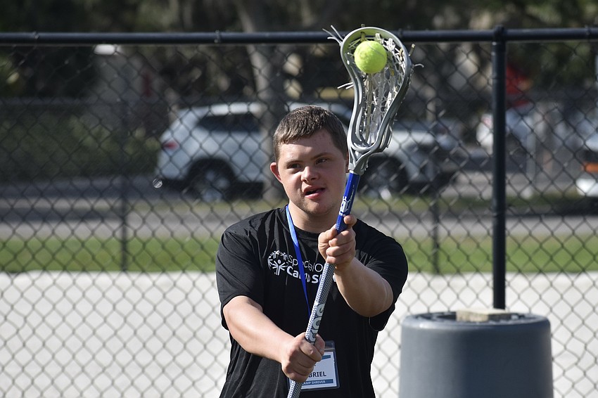Gabriel, 19, takes a swing in lacrosse.