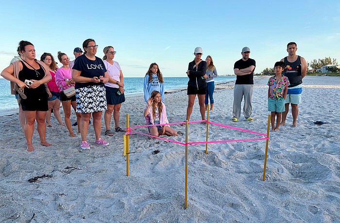 Members of the public curious to learn more about Longboat Key's sea turtle population ask questions of the experts at the first Turtle Walk of the nesting season on June 6 beside the newly staked nest.