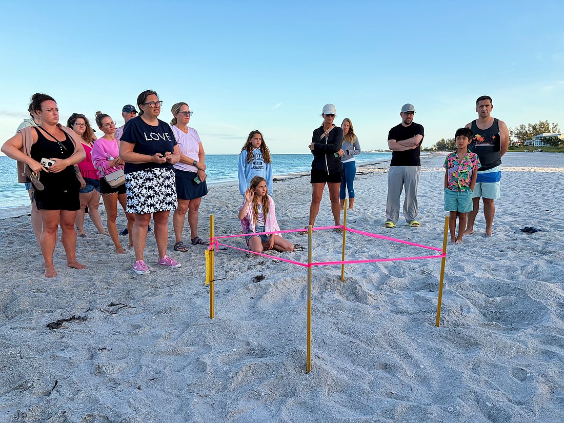 Members of the public curious to learn more about Longboat Key's sea turtle population ask questions of the experts at the first Turtle Walk of the nesting season on June 6 beside the newly staked nest.