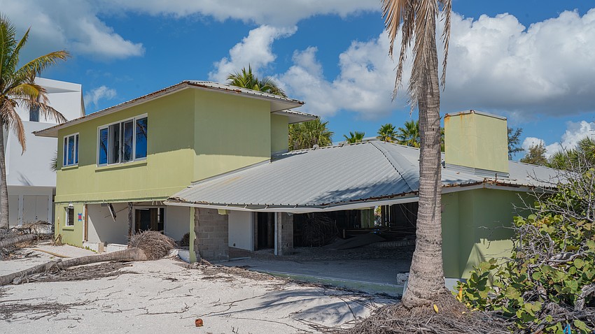 A palm tree and sand inside the house, and a sagging roof above are evidence of the damage the house at 6601 Gulfside Road sustained from the 2024 hurricanes. A palm tree and sand inside the house, and a sagging roof above are evidence of the damage the house at 6601 Gulfside Road sustained from the 2024 hurricanes.