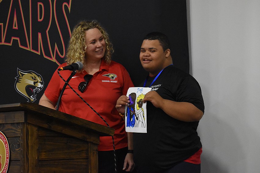 Liz Chappell lets Jordan welcome the campers during the opening ceremony.