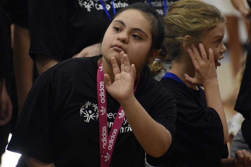 Gabby, age 15, offers a greeting.