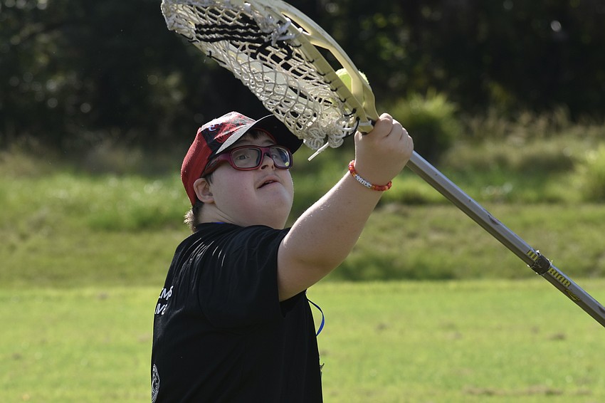 Aitan, 15, catches a ball in lacrosse.