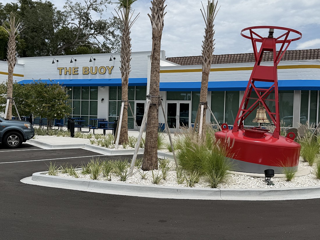 A red buoy in the parking lot serves as a beacon to attract customers to The Buoy at 4323 Herschel St.