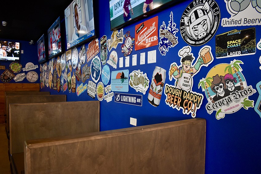 The blue walls covered in signs have been recreated for the new location.