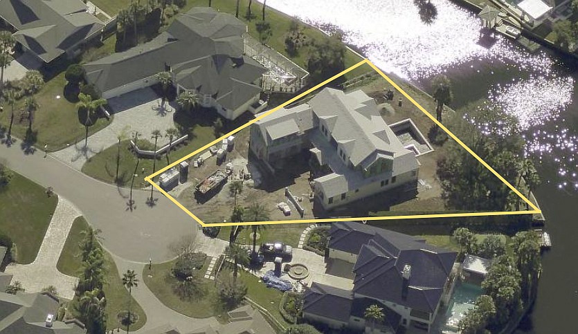Waterfront two-story home features five bedrooms, five full and two half-bathrooms, office, butler pantry, pool, porches, patio, outdoor kitchen and two-car garage.
