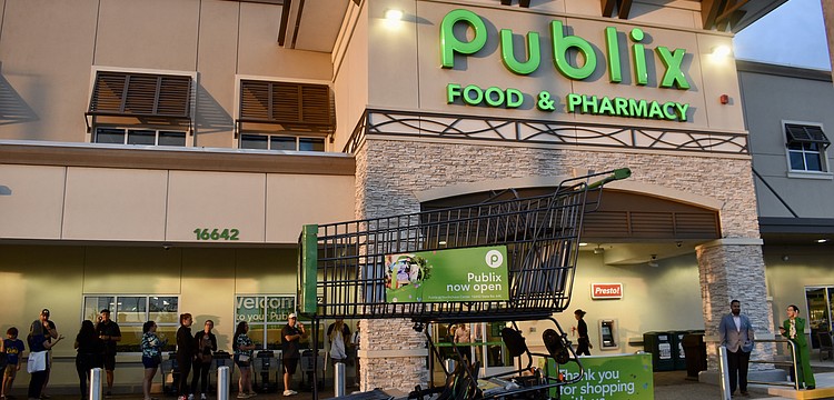 East County residents wait in line before 7 a.m. on June 11 to start shopping at the new Publix at 16642 State Road 64 East.