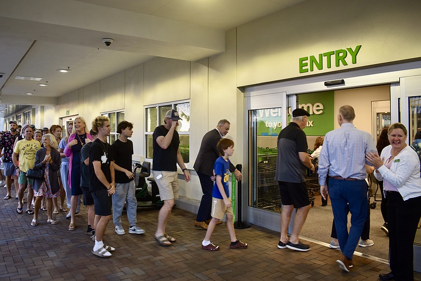 Eager customers stream into the Publix at Northchase Center June 11.