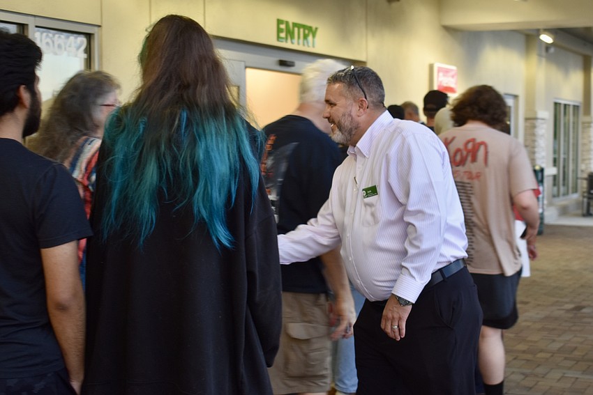 Store Manager Josh Jordan introduces himself to a line of Publix shoppers.