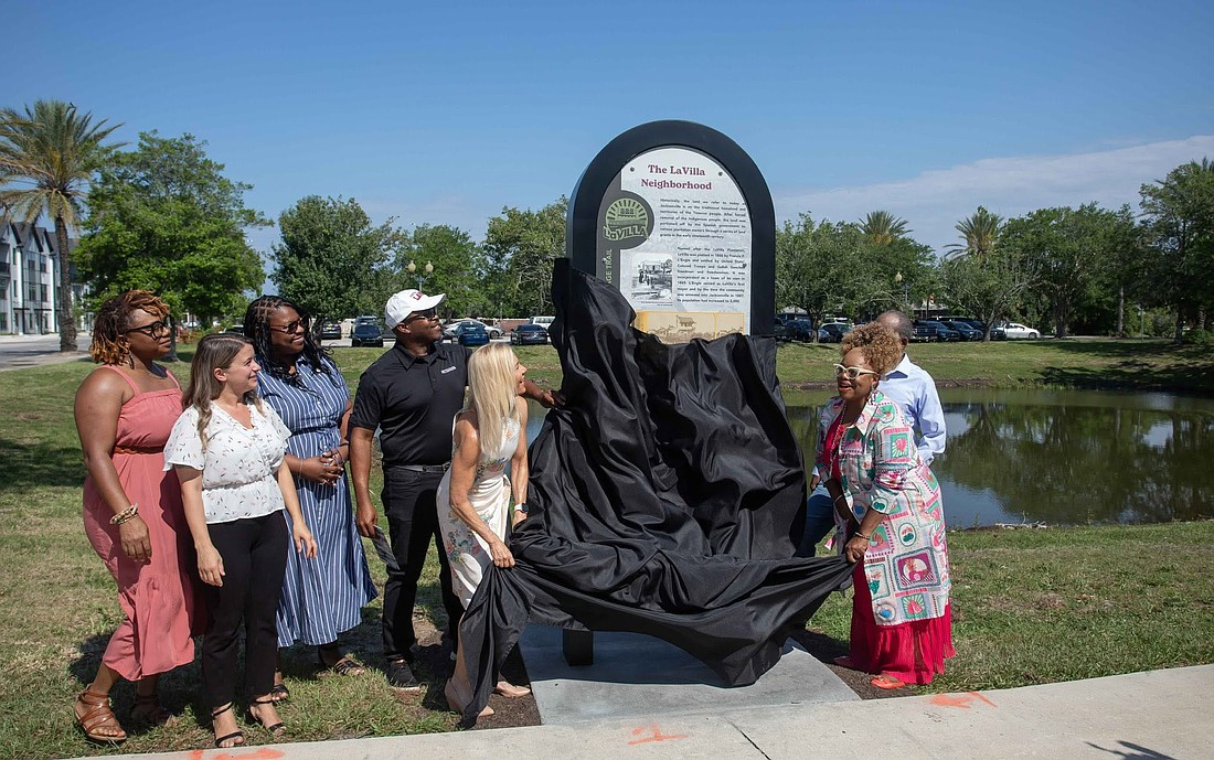 Jacksonville City Council member Ju’Coby Pittman, right, and Mayor Donna Deegan unveil the first marker on the LaVilla: Lift Ev’ry Voice and Sing Heritage Trail during an opening event for the 1.76-mile walking route. Behind Deegan is Ennis Davis, a Jacksonville planner, historian and leading member of the LaVilla Heritage Trail and Gateway Committee.