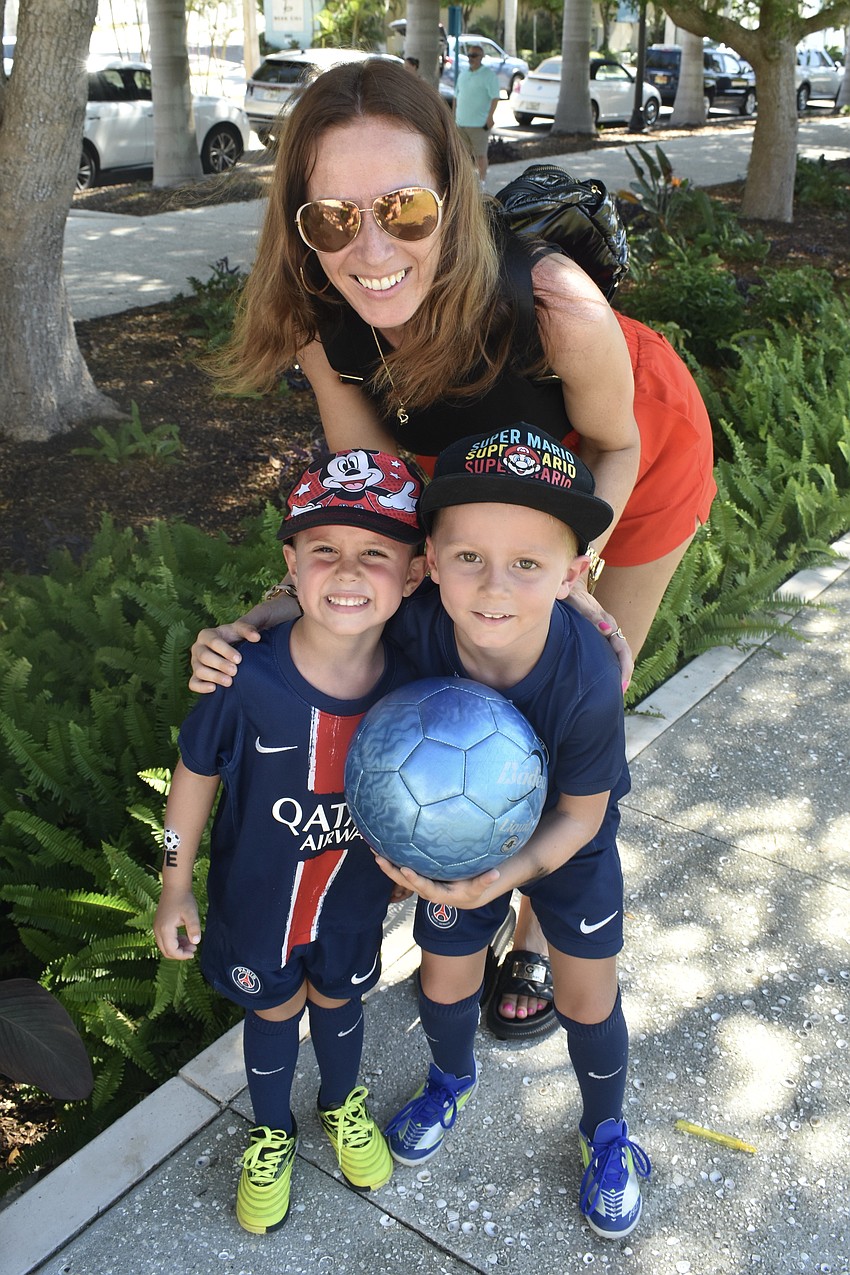 Timon Sofka, 4, his mother Veronika Sofka and his brother Maxim Sofka, 6, enjoy an afternoon of soccer.
