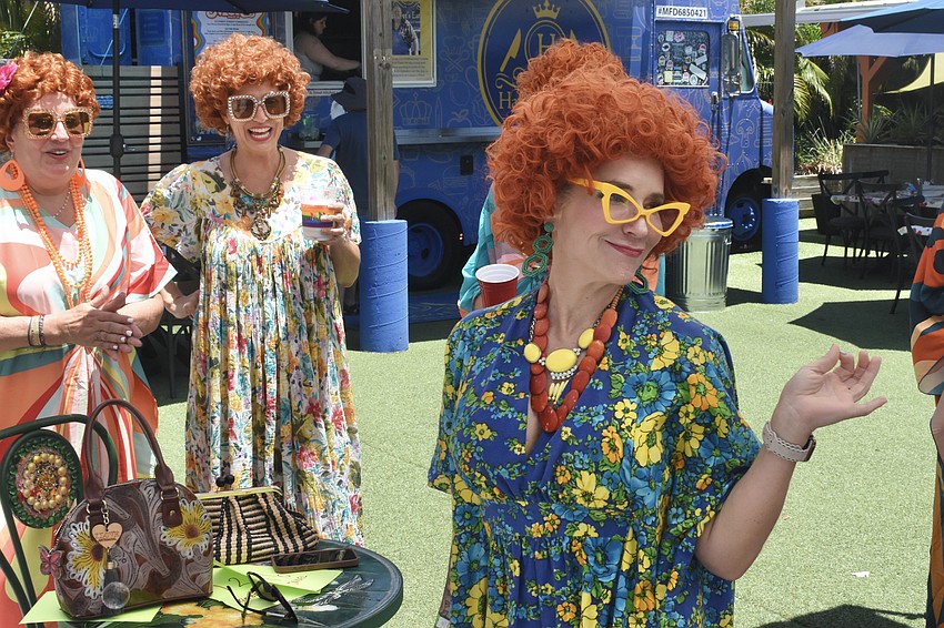 Tammy Hauser and Allison Kummery watch as Kimberly O'Neill strolls towards the stage.