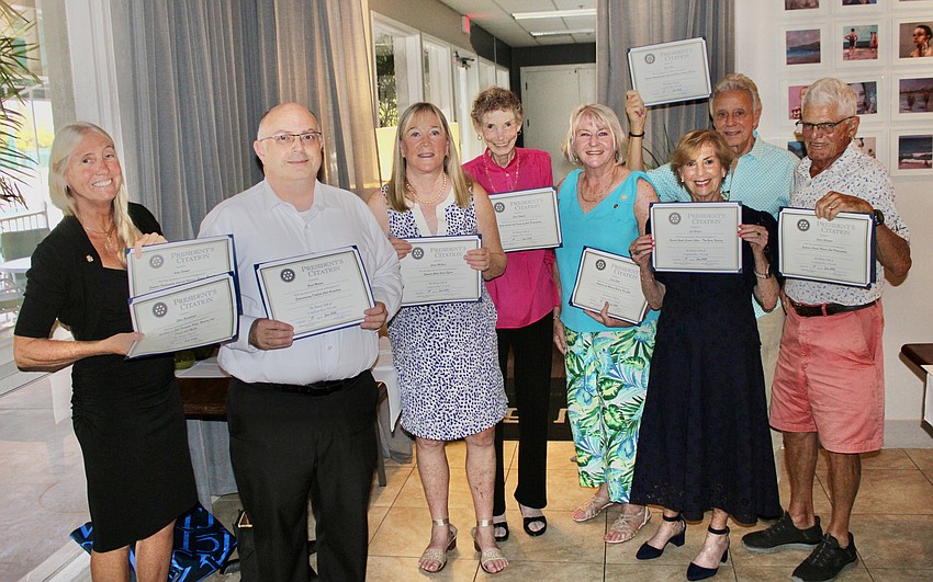 Rotary Club of Longboat Key President Terri Driver presents Presidential Award Certificates to Brad Marner, Susan McGuire, Janet Shapiro, Carol Erker, Jan Wallace, Eugene Luca and James Chirgwin. Recipients not pictured were Ellen Greenberger and Andrew Sawyer.