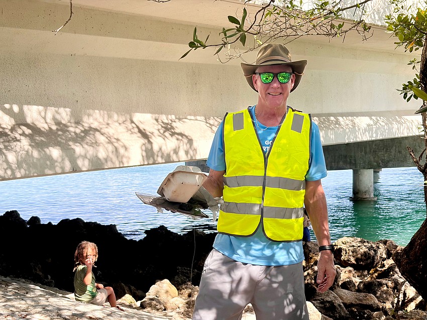 Manasota Track Club board member Rob Loeffler lends a hand collecting trash at the club's quarterly cleanup, keeping the shores of the New Pass area clear.