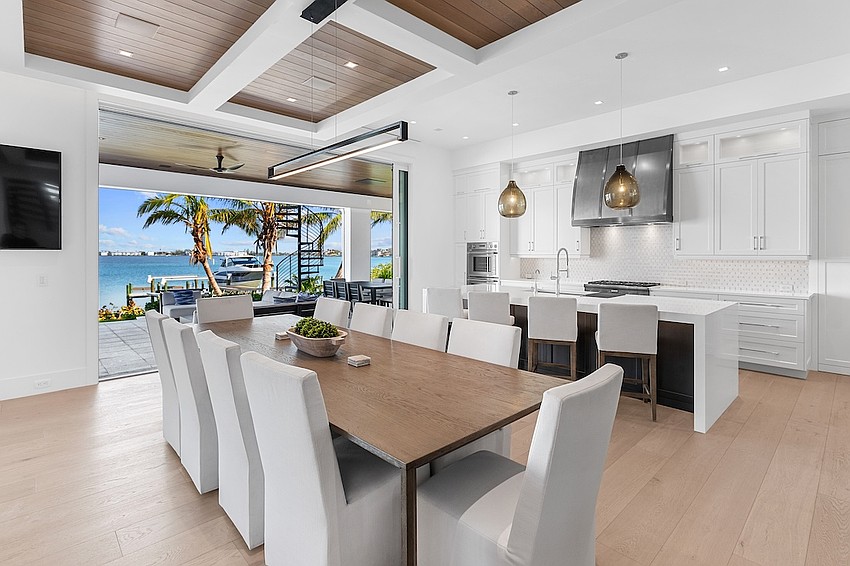 The house features views of Sarasota Bay, an infinity-edge pool, multiple seating areas and an outdoor kitchen.