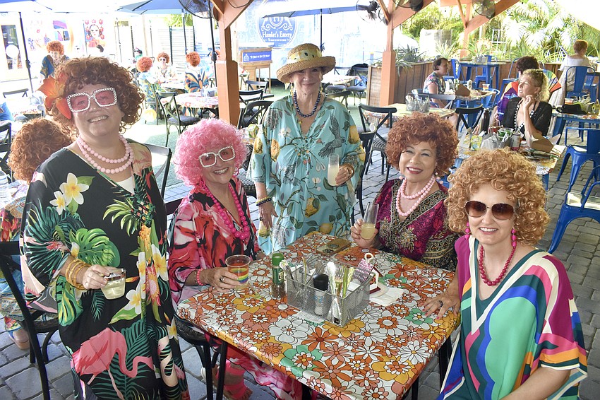 Sara Osten, Kim Sutton, Sara Osten's mother Carol Osten, Marie Carlock and Tracey Gonzalez gather round the table.