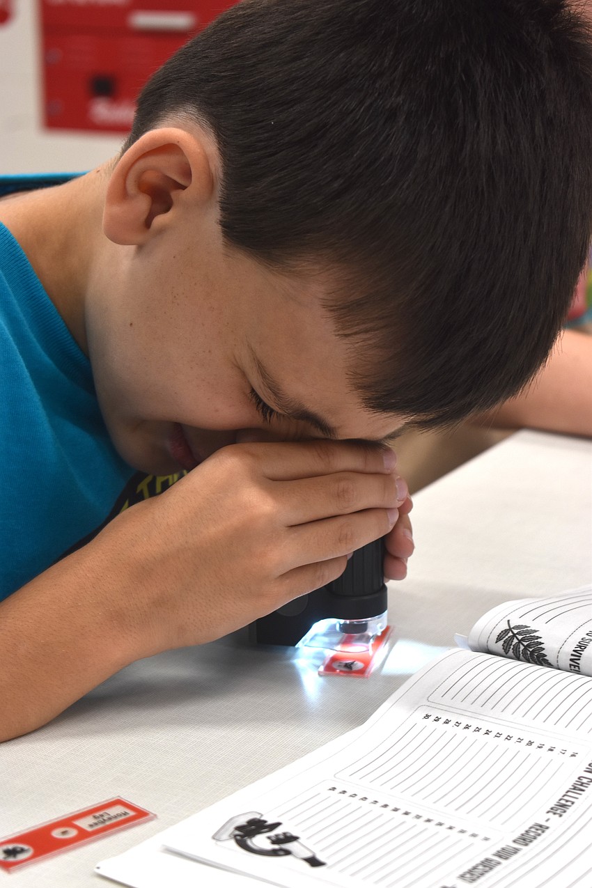 Owen Quisenberry, a rising fourth grader at Tatum Ridge Elementary School, says despite not being a big fan of science, it was cool to use the microscope.