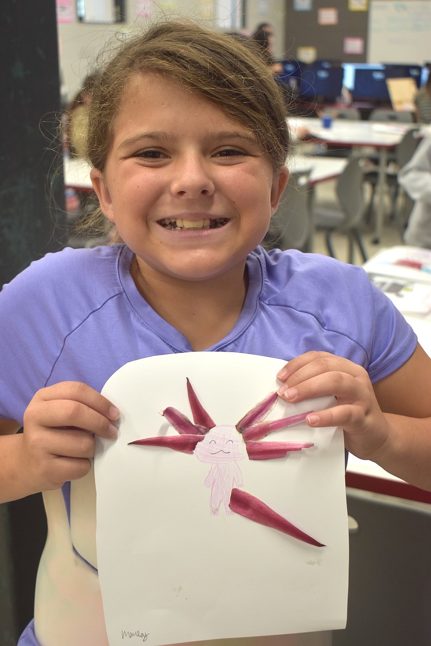 Marley Smith, a rising fifth grader at Lake Manatee K-8, is proud to show off her leaf artwork of her favorite animal, an axolotl.