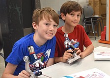 Eadon Foster, a rising fourth grader at Gilbert W. McNeal Elementary, and  
Zion Stenzler, a rising fifth grader at Rowlett Elementary Academy, each use microscopes to look at a goldfish scale, dandelion fuzz, pollen, and more.