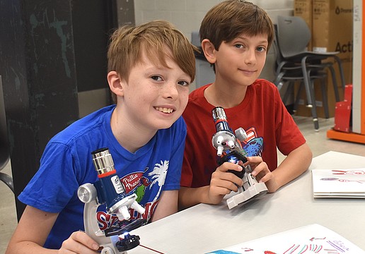 Eadon Foster, a rising fourth grader at Gilbert W. McNeal Elementary, and  
Zion Stenzler, a rising fifth grader at Rowlett Elementary Academy, each use microscopes to look at a goldfish scale, dandelion fuzz, pollen, and more.