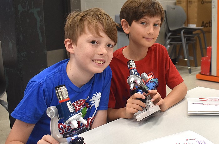 Eadon Foster, a rising fourth grader at Gilbert W. McNeal Elementary, and  
Zion Stenzler, a rising fifth grader at Rowlett Elementary Academy, each use microscopes to look at a goldfish scale, dandelion fuzz, pollen, and more.