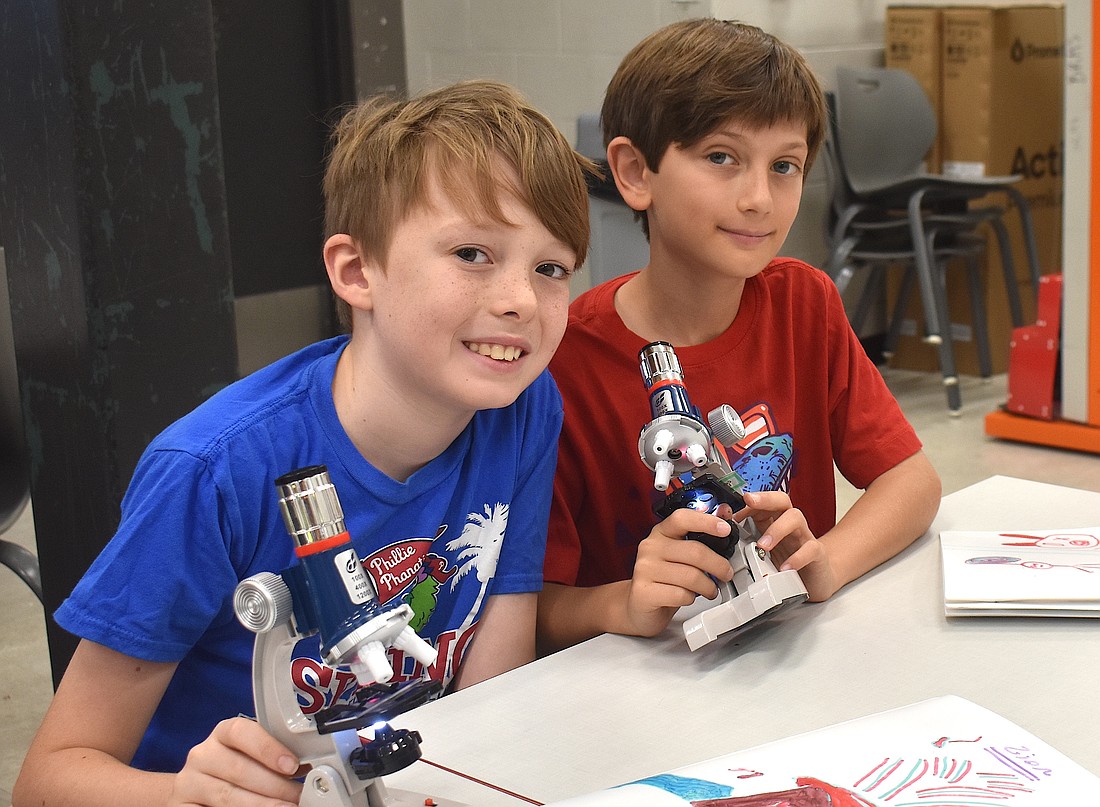 Eadon Foster, a rising fourth grader at Gilbert W. McNeal Elementary, and  
Zion Stenzler, a rising fifth grader at Rowlett Elementary Academy, each use microscopes to look at a goldfish scale, dandelion fuzz, pollen, and more.