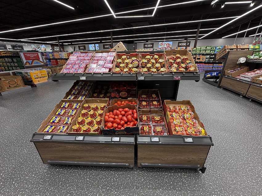 Fresh tomatoes dominate an endcap in the produce section. Fresh tomatoes dominate an endcap in the produce section.
