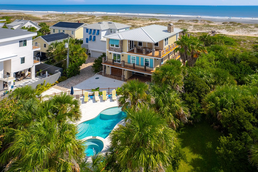 Two-story home features four bedroom, five full and one half-bathrooms, flex space, porches, pavilion with outdoor kitchen, pool house and pool.