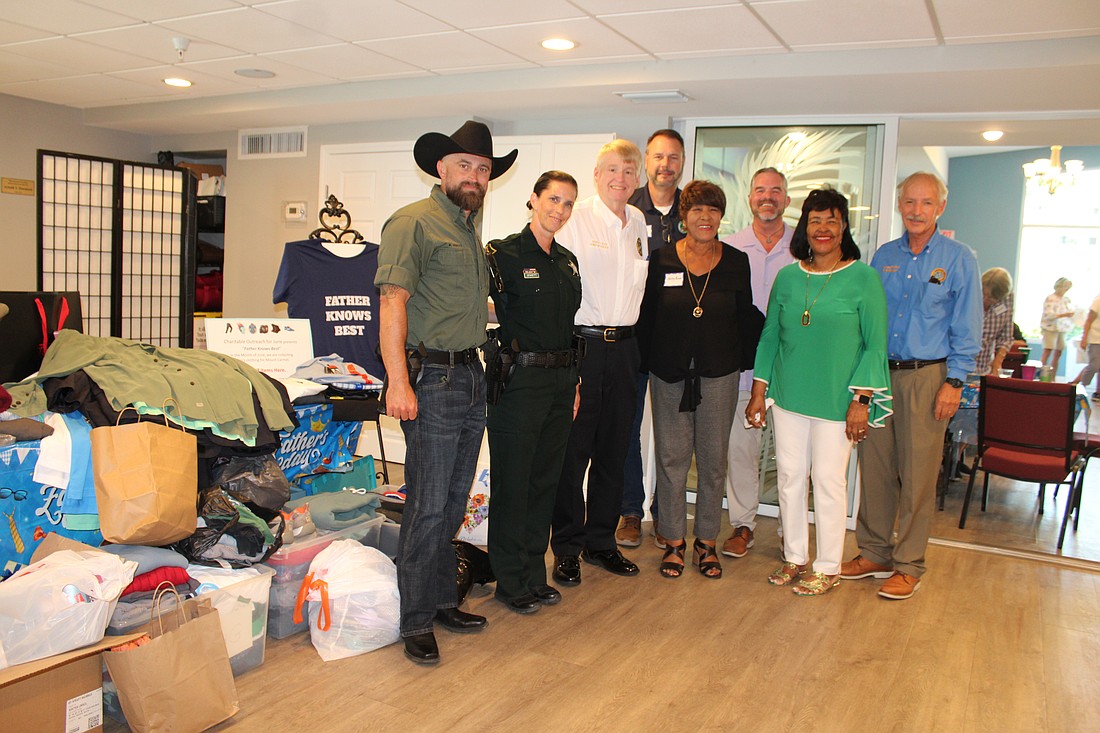 Palmetto community leaders showed up strong at Longboat Island Chapel's latest charity drive to support Mt. Carmel Resource Center on June 16. From left, Deputy Ken Jewett, Sgt. Joy Jewett, Chief of Police Scott Tyler, City of Palmetto Mayor Daniel West, Shirley Pearson, executive director of Strength in Action, Inc., Rev. Brock Patterson, Pearson's sister Laura Wallace, and Town of Longboat Key Town Manager Howard Tipton.