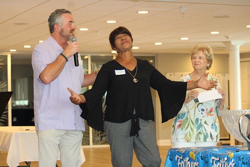 Shirley Pearson gives a heartfelt thank-you to supporters from Longboat Key as Rev. Brock Patterson and Jamie Engel present a check to support her and her team's work with the Mt. Carmel Resource Center.